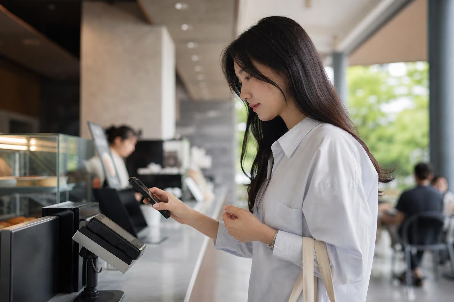 Customer presenting a government-issued mobile ID at a service counter in South Korea