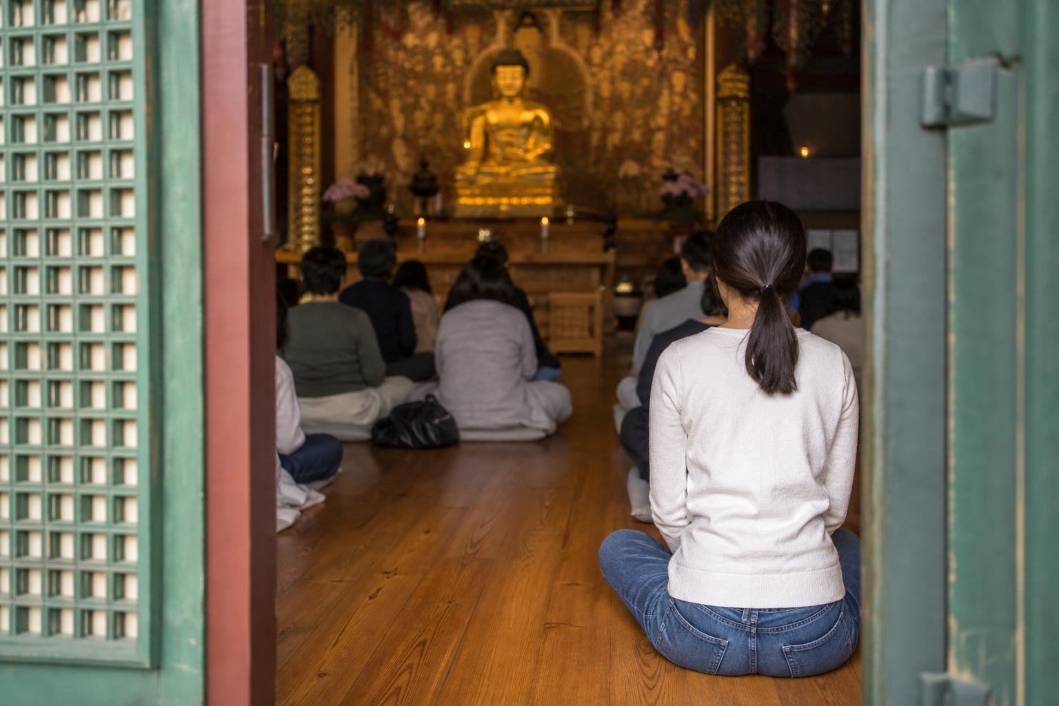 Neatly arranged shoes and clean socks beside the entrance to a Buddhist prayer hall