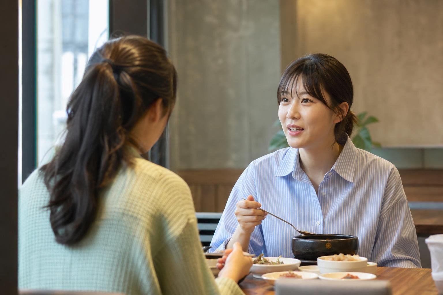 Phone screen showing a parent asking an adult child 밥은 먹었어?